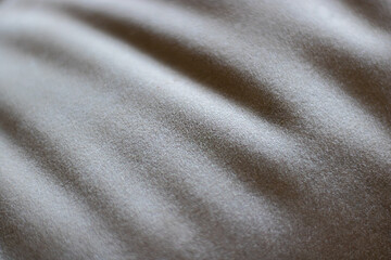 Fototapeta premium Extreme close-up abstract view of a soft grey textured fabric with subtle folds. Represents texture and material.