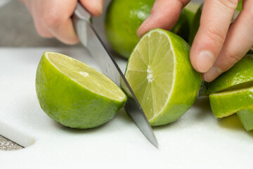 Cutting Fresh Lime in Half with Kitchen Knife