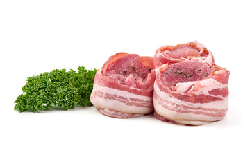 Raw pork medallions wrapped in bacon with curly parsley, isolated on white background.