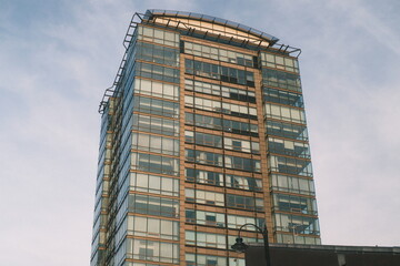 A highly detailed photo of a tall building with a clock on top of it with artistic lighting....