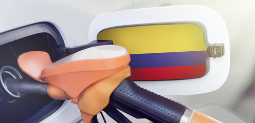 The flag of Colombia on the lid of the gas tank of a car at a gas station in close-up. High or low...