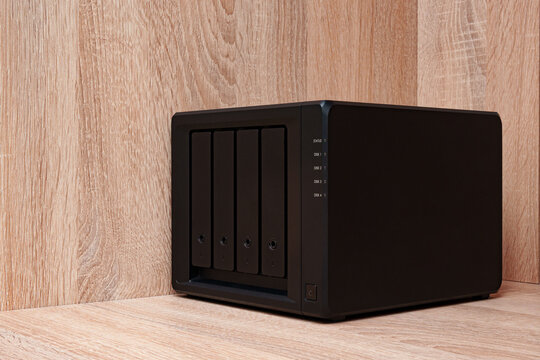 NAS server. Network storage. Device for backing up important information on a brown shelf. Place for text.