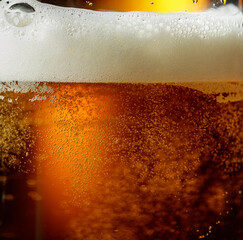 Glass of beer with foam, closeup.