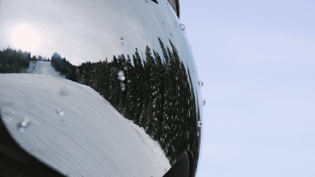 Close up macro goggles reflection skiers ski in ski resort enjoy fresh snow ski by forest in canada mountains outdoors. Gear eye UV protection concept