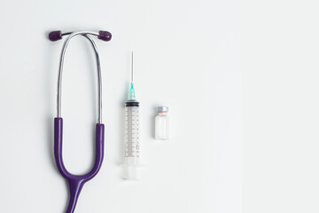 Medical layout on white background, flat. stethoscope or phonendoscope with test tube, bottle or ampoule, vaccine vial, syringe, copy space, space for text. © Luqman Aditiamala