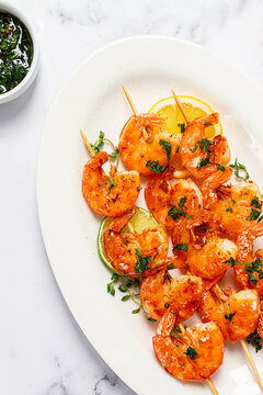 Fried shrimp, headless, on skewers, shrimp kebabs, with spices and herbs, grilled, homemade, without people,