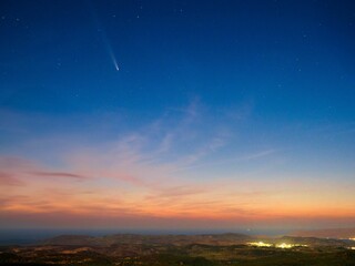 Comet streaking across a starry night sky.