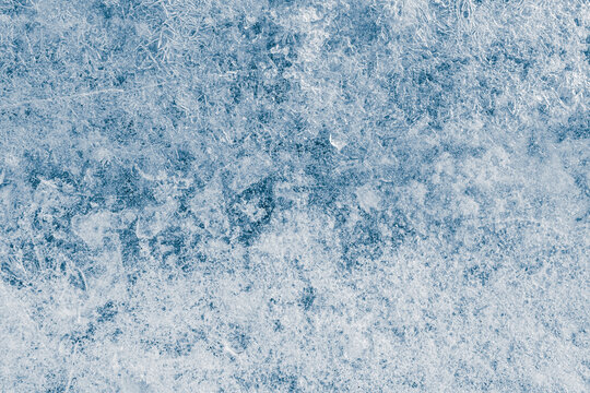Ice texture crystal, blue tones background. Textured cold frosty surface of ice.