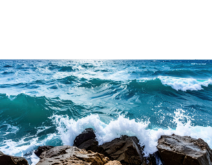 Powerful ocean waves crash against rugged rocks under a clear horizon.