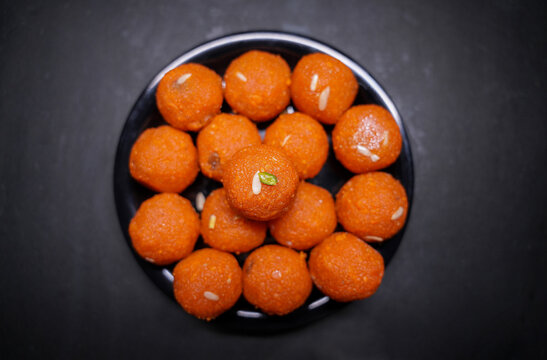 Close up of Indian traditional sweet Laddu served in a black bowl