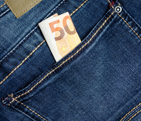 50 Euros in the pocket of blue jeans close-up