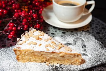Slice of Tuscan pine nut cake with coffee.