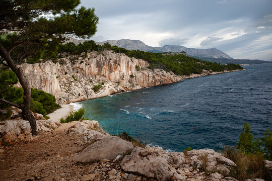Beautiful landscape in Park Osejava near Makarska, Croatia. Gravel path in forest near Adriatic sea. Nugal Beach.
