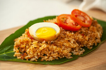 Delicious Fried Rice with Boiled Egg and Tomato on a Leaf