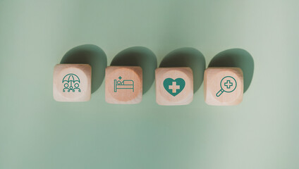 Health insurance concept. Health care checkup and healthy trends. Access to welfare health. Wellness and medical. Wood cube and healthcare insurance icon on pastel green background. World health day