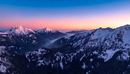 Peaceful winter mountain landscape during sunset with snow-capped peaks and serene pastel sky