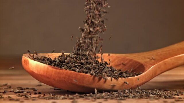 Cumin falls on a wooden spoon. Filmed on a high-speed camera at 1000 fps. High quality FullHD footage