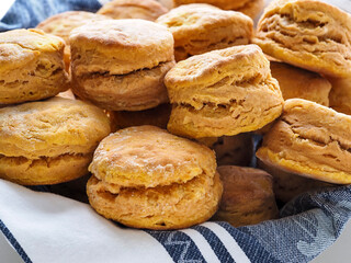 Close up of a basket of basked flaky sweet potato biscuits