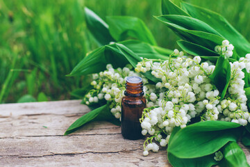 Lily of the valley extract in a bottle. Selective focus.