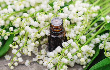 Lily of the valley extract in a bottle. Selective focus.