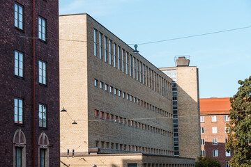An urban view of diverse architectural styles in Helsinki's buildings under a blue sky.