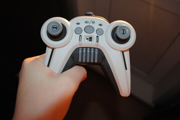 Playing console video games. Controller in hands close-up.