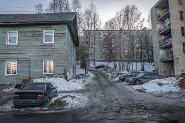 An old neighborhood in Petrozavodsk, featuring weathered wooden houses and showing signs of...