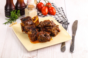 Prepared tasty beef ribs with sauce