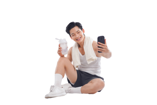 Portrait of muscular Asian man in sportswear sitting posing on white background	
