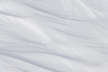 Abstract textured wavy line patterns on plain white winter snow background