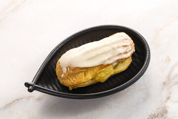 Delicous eclair with ising and cream