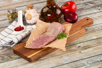 Raw pork tongue over board