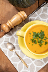 Pumpkin broth on wooden background
