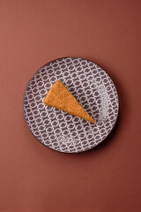 A slice of honey puff cake or pumpkin, carrot and cream pie, vegan sweets