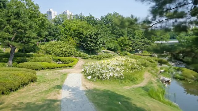 Lush Garden Landscape with Green Bushes Trees Grass and Winding Stone Path