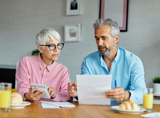 woman man senior bill finance retirement couple home wife budget husband mature business meeting...