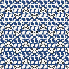 repeating geometric pattern featuring stylized flowers and leaves. The color palette is limited to blue, white, and black. The flowers have a white center surrounded by black dots, with blue petals.