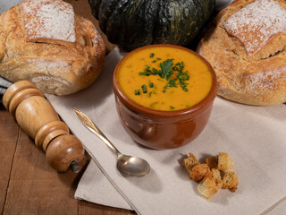 Pumpkin broth on wooden background