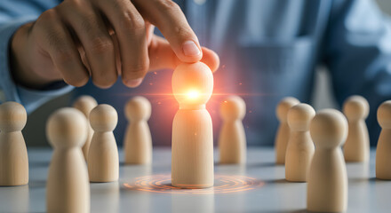 Hand Selecting Glowing Wooden Figure for Business Leadership Success and Growth in Gray Blurry Background
