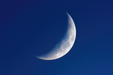 Moonlit Crescent Against Blue Evening Sky