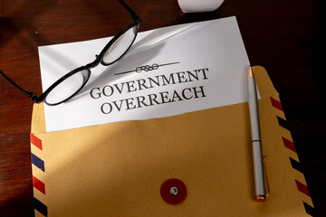 Legal Notice on Government Overreach Placed on Desk with Pen