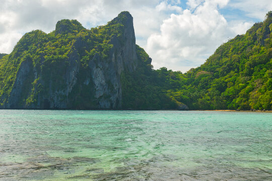 PALAWAN, PHILIPPINES - DECEMBER 21, 2023: Landscape of the beautiful mountain cliff in the sea, El Nido province in Palawan island in Philippines. 6 million tourists visited Philippines in 2016.