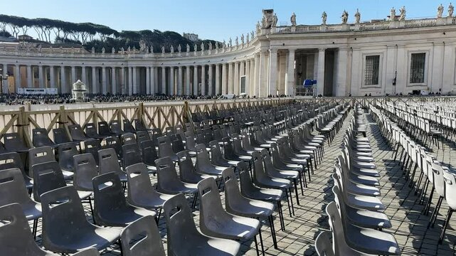 Empty row of chairs at Saint Peter square in Vatican as preparation for Eastern holiday ceremony on spring sunny day