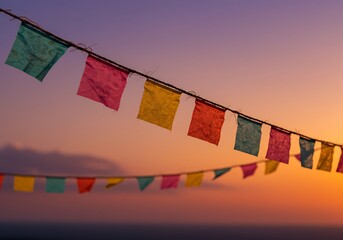 Colorful festive flags hanging against a vibrant sunset sky celebration party