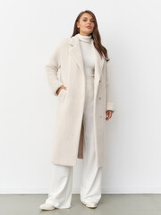 Elegant woman models contemporary fashion in stylish studio setting during daytime