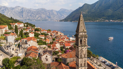 Aerial view of Perast city on a sunny day. Old venetian tourist town located in the Adriatic Sea coast in the Bay of Kotor, Montenegro