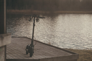 A scooter on a wooden bridge