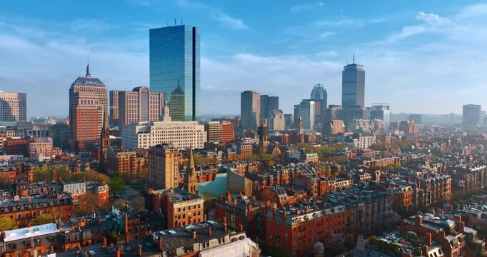 Flight above the remarkable old architecture of Boston. Approaching the beautiful modern high-rise buildings in the downtown. Aerial perspective on sunny day.