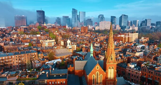 Orange buildings of the old district of Boston, Massachusetts, USA. Skyscrapers at backdrop are coated in smoke. Aerial perspective.
