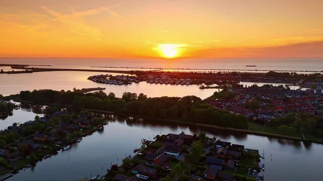 Sunset above the picturesque village on the water. Beautiful scenery of Vinkeveen, the Netherlands. Aerial view.